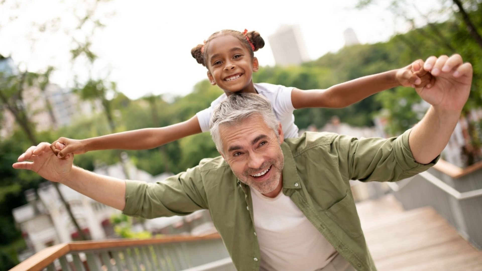 Girl and dad playing together outside